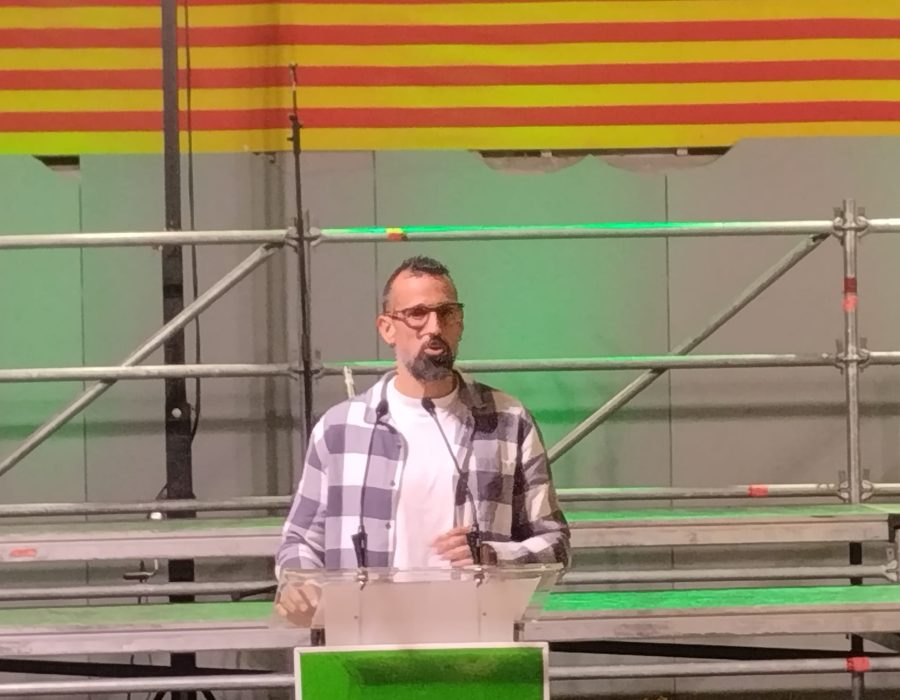 Roger hablando en un atril en la cantada de corales contra el cáncer de Alguaire